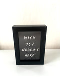 Framed 'Wish you weren't here' postcard